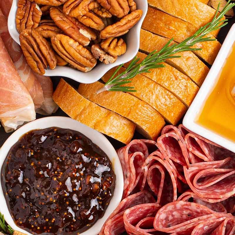 A cheese, chutney, charcuterie, fruit, biscuits and meat board
