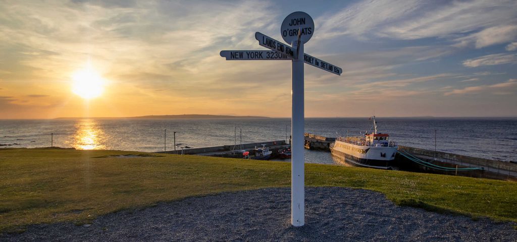 The John O' Groats sign post at sunset