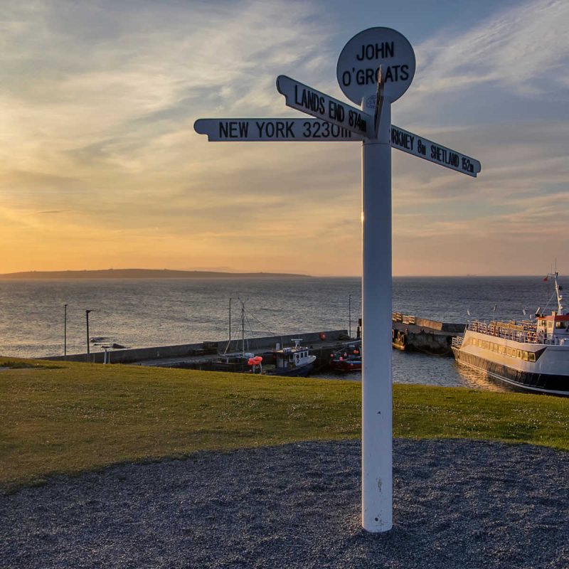 The John O' Groats sign post at sunset