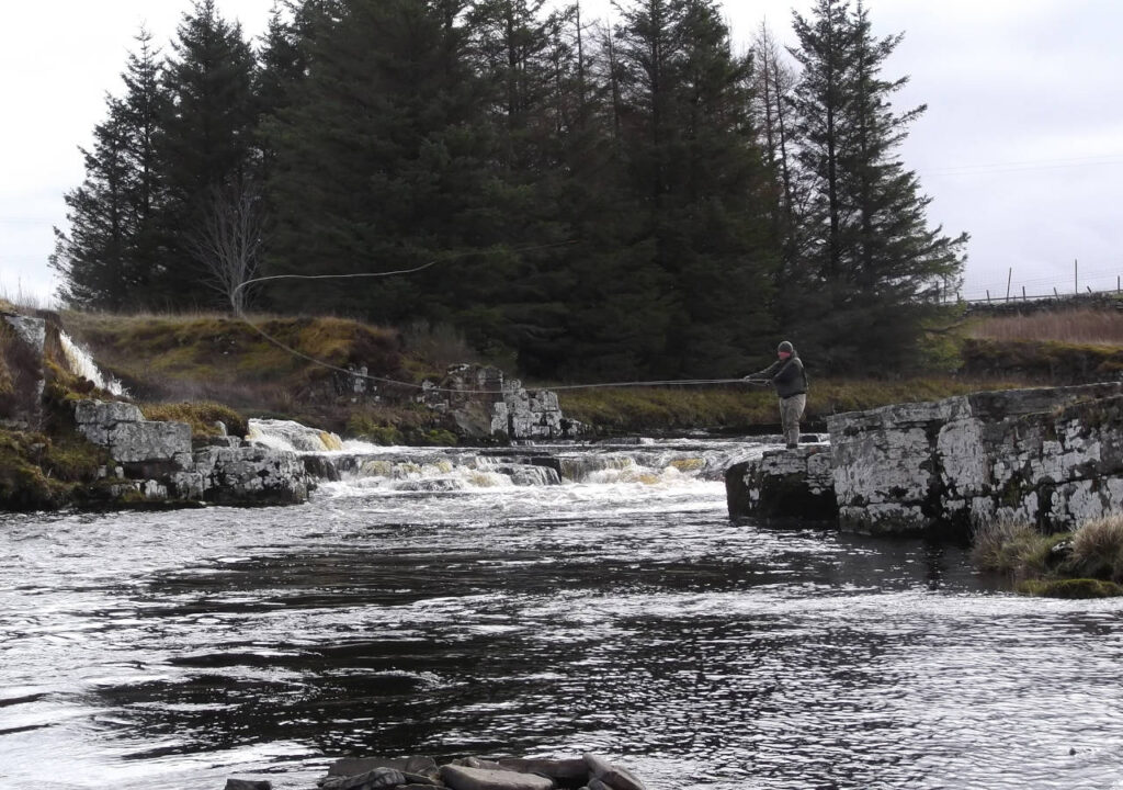 Man fishing on the River Thurso in Scotland