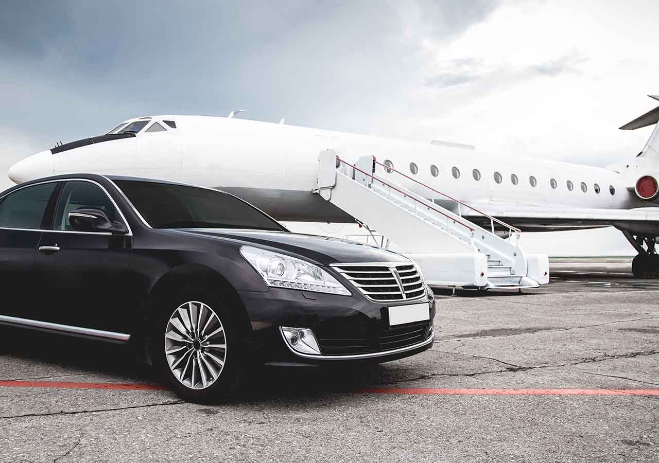 A hire car sits in front of a plane.