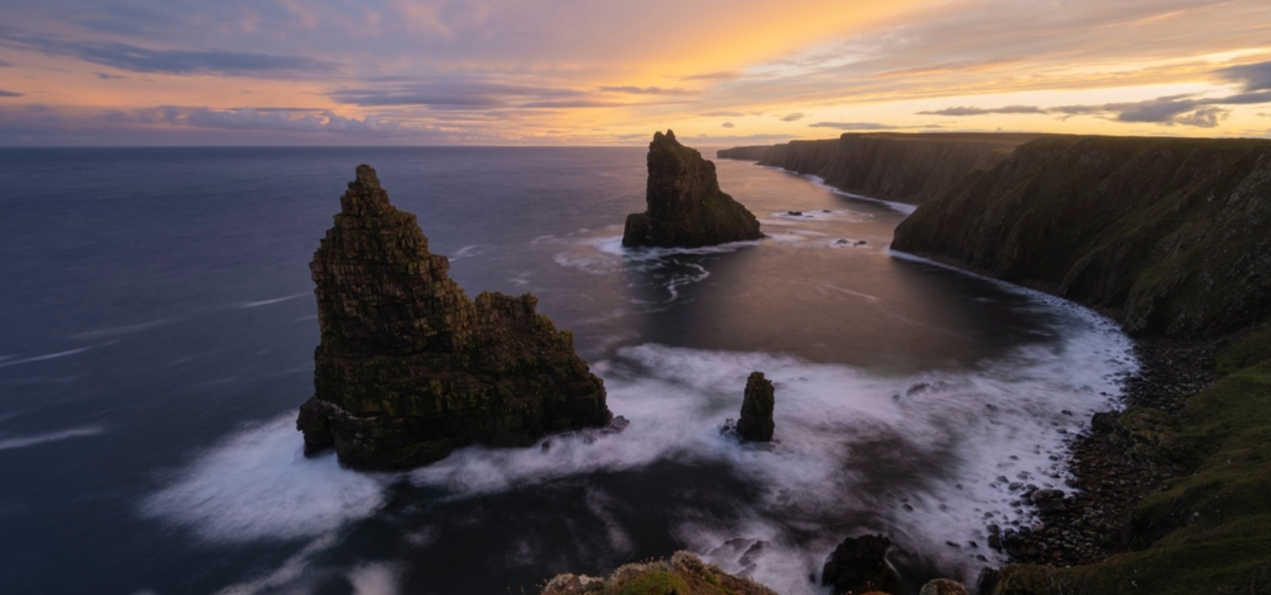 The dramatic coastline of Duncansby Head with the Duncansby Stacks in Caithness, Scotland.
